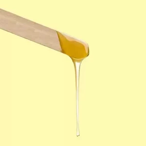 Sugar wax dripping from a spatula