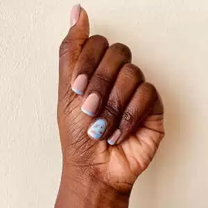 Decorated (light blue and light pink) short nails after an acrylic manicure by Viv's in-Houz spa's mobile nail technician in Nairobi